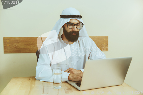 Image of Arabian saudi businessman working in office