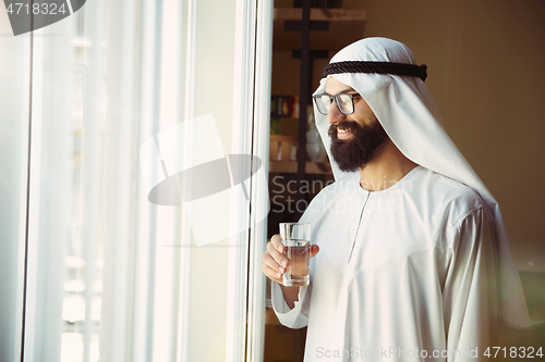 Image of Arabian saudi businessman working in office