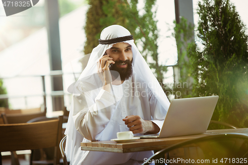 Image of Arabian saudi businessman working outdoors