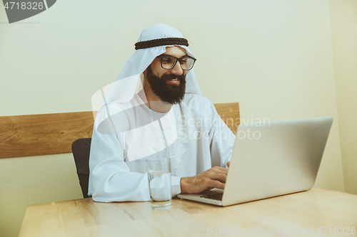 Image of Arabian saudi businessman working in office