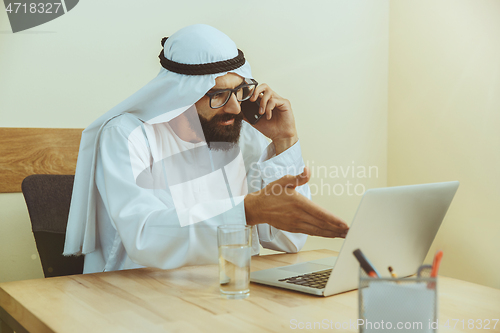 Image of Arabian saudi businessman working in office