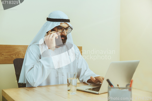 Image of Arabian saudi businessman working in office