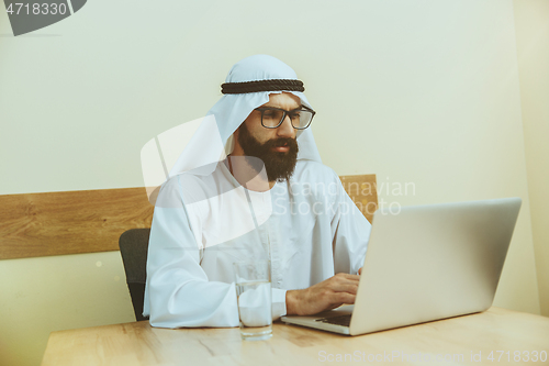 Image of Arabian saudi businessman working in office