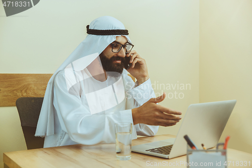 Image of Arabian saudi businessman working in office