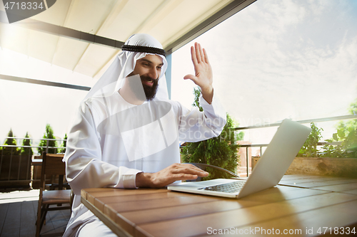 Image of Arabian saudi businessman working outdoors