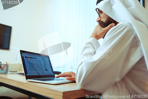 Image of Arabian saudi businessman working in office