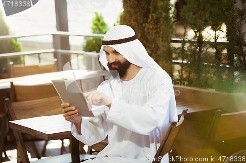 Image of Arabian saudi businessman working outdoors