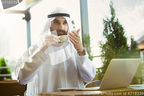 Image of Arabian saudi businessman working outdoors