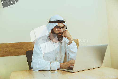 Image of Arabian saudi businessman working in office