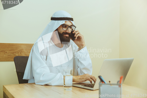 Image of Arabian saudi businessman working in office