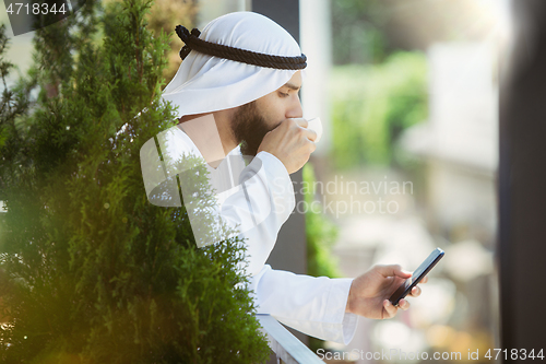 Image of Arabian saudi businessman working outdoors