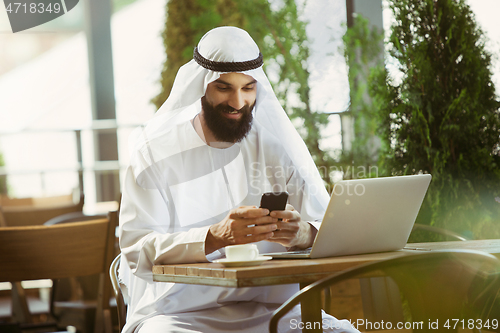 Image of Arabian saudi businessman working outdoors