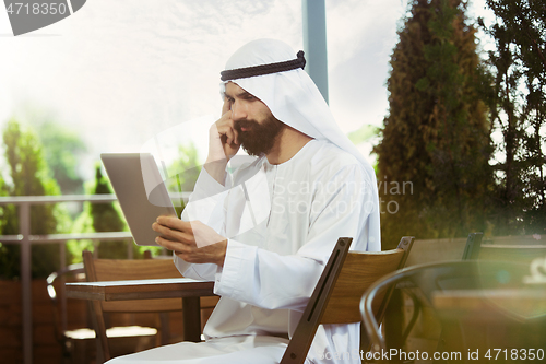 Image of Arabian saudi businessman working outdoors