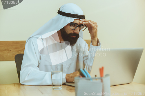 Image of Arabian saudi businessman working in office