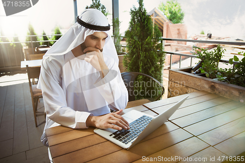 Image of Arabian saudi businessman working outdoors