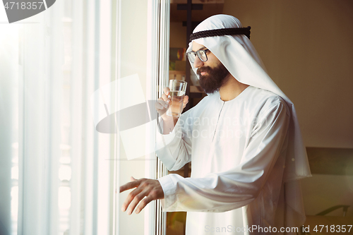 Image of Arabian saudi businessman working in office