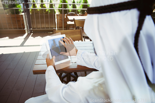 Image of Arabian saudi businessman working outdoors