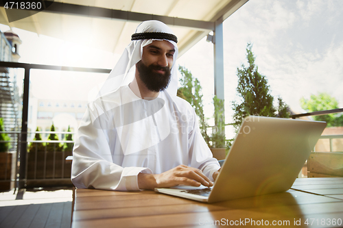 Image of Arabian saudi businessman working outdoors