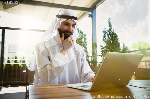 Image of Arabian saudi businessman working outdoors