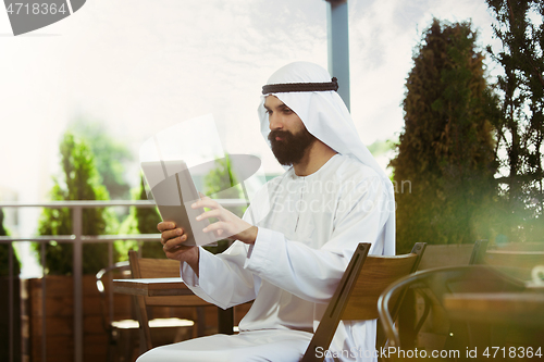 Image of Arabian saudi businessman working outdoors