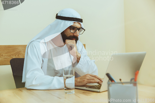 Image of Arabian saudi businessman working in office