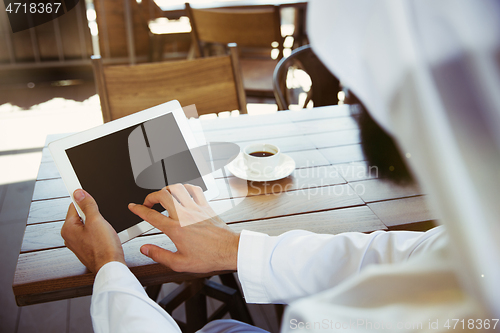 Image of Arabian saudi businessman working outdoors