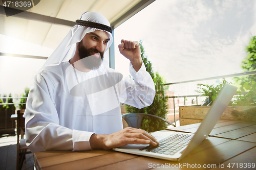 Image of Arabian saudi businessman working outdoors