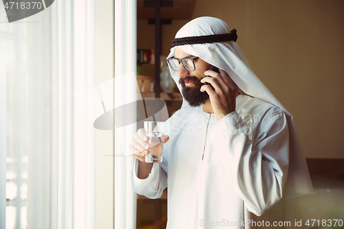 Image of Arabian saudi businessman working in office