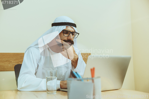 Image of Arabian saudi businessman working in office