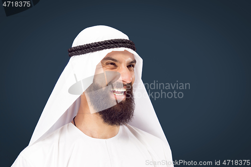 Image of Arabian saudi businessman on dark blue studio background