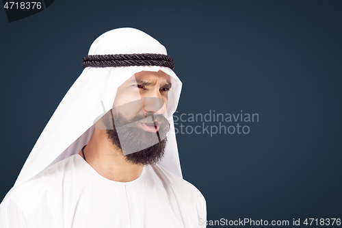 Image of Arabian saudi businessman on dark blue studio background