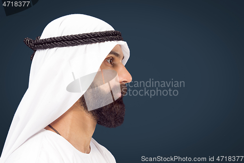 Image of Arabian saudi businessman on dark blue studio background