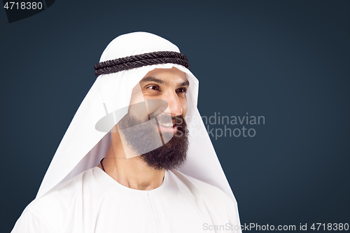 Image of Arabian saudi businessman on dark blue studio background