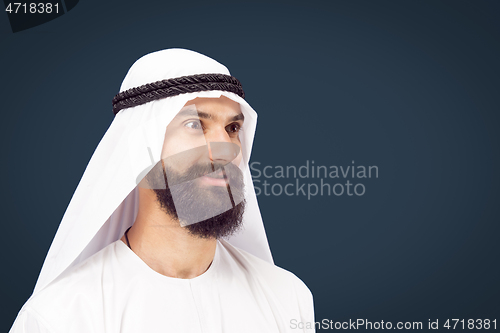 Image of Arabian saudi businessman on dark blue studio background