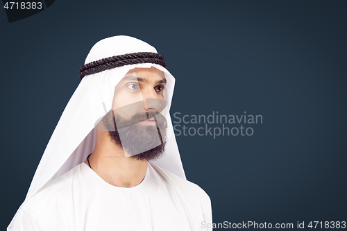 Image of Arabian saudi businessman on dark blue studio background