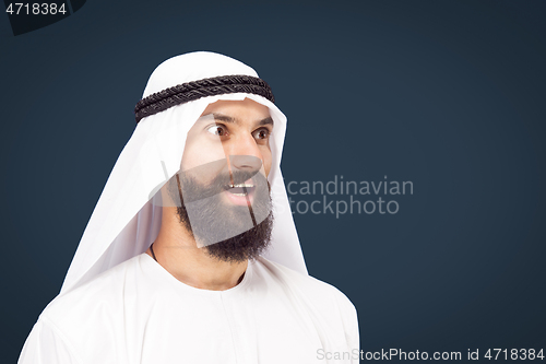 Image of Arabian saudi businessman on dark blue studio background