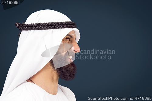 Image of Arabian saudi businessman on dark blue studio background