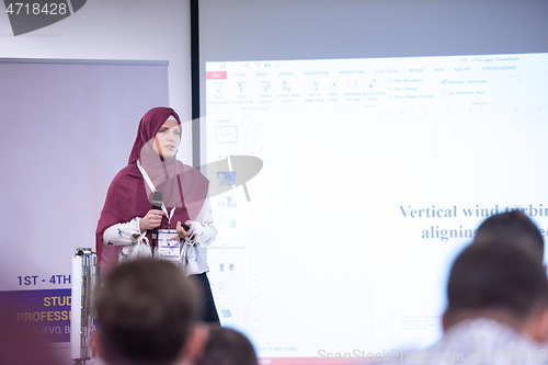 Image of Muslim businesswoman giving presentations at conference room