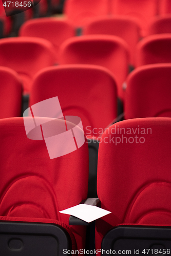 Image of hall with rows of red seats