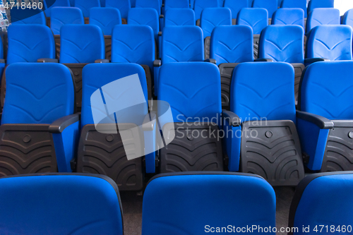 Image of hall with rows of blue seats
