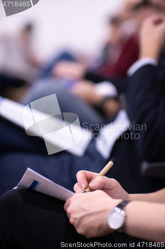 Image of business people taking notes