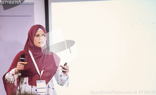 Image of Muslim businesswoman giving presentations at conference room