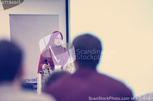 Image of Muslim businesswoman giving presentations at conference room