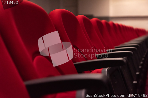 Image of hall with rows of red seats