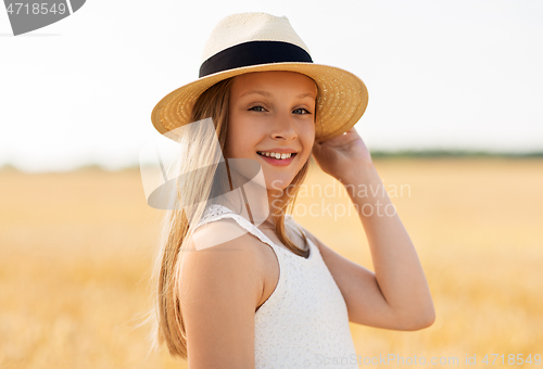 Image of portrait of girl in straw hat on field in summer