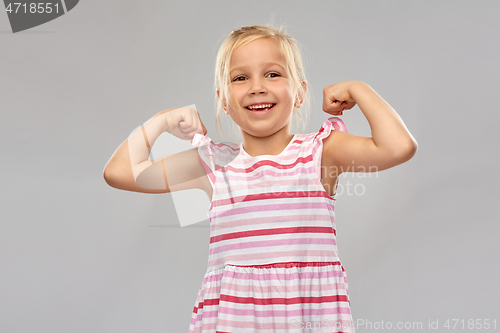 Image of smiling little girl showing her power