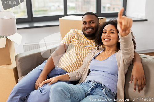 Image of happy couple with boxes moving to new home