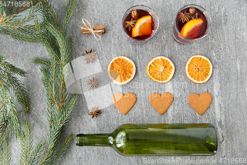 Image of mulled wine, orange slices, gingerbread and spices