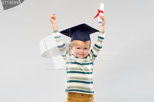 Image of smiling little boy in mortar board with diploma