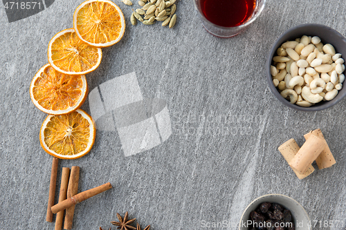 Image of hot mulled wine, orange slices, raisins and spices